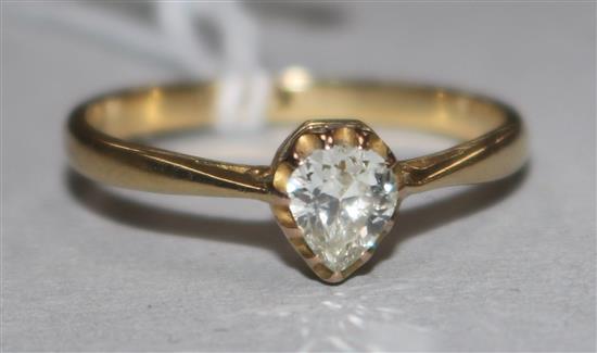 An 18ct gold and solitaire pear shaped diamond ring, size N.